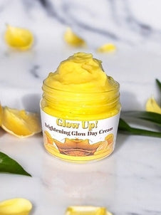 Glow Up Brightening Day Cream in yellow jar with nourishing ingredients for radiant skin