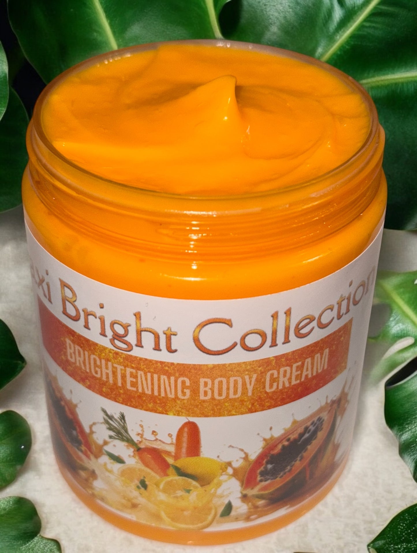 Maxi Bright Body Bundle Brightening Body Cream in a jar with vibrant orange color and natural ingredients